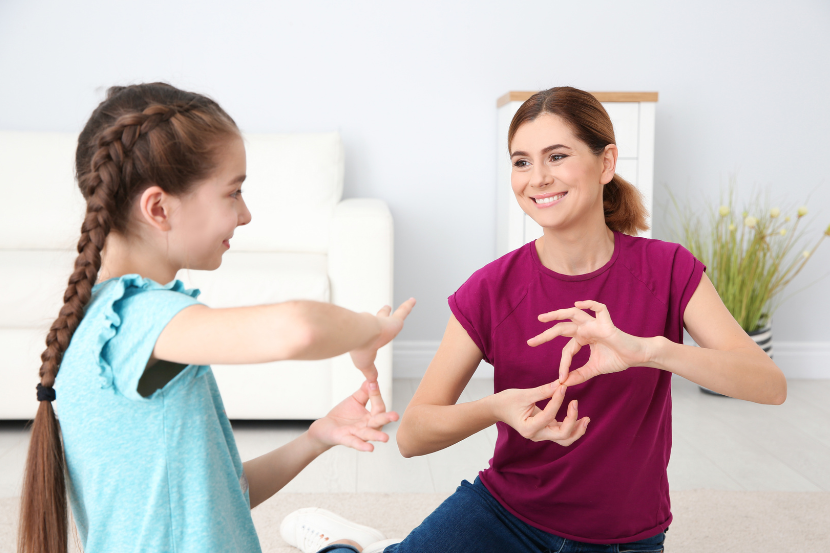 mãe e filha praticando linguagem de sinais